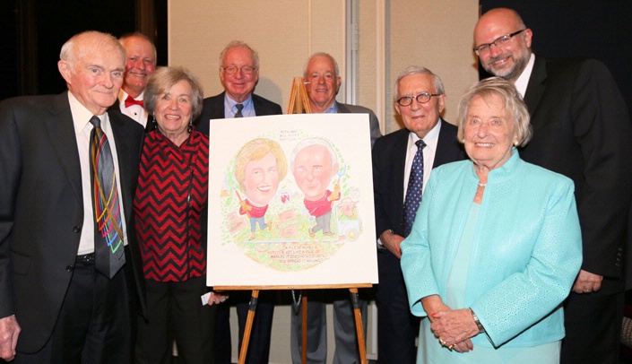 Two huge supporters of UNMC, Omaha philanthropists Bill Scott, far left, and Ruth Scott, second from right, were honored Sept. 22 as the Omaha Press Club's 150th Face on the Barroom Floor. The Scotts are seen here with their Face caricature. Behind them are their roasters, from left: Terry Pettit, Judy Duffy, Dr. Randy Ferlic, Bruce Rasmussen, Dr. Michael Sorrell and Dr. Nick Stergiou. (Photo by Gary Willis)