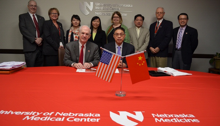 Attendees at the Nov. 14 signing ceremony included: Front row (left-right) - UNMC Chancellor Jeffrey P. Gold, M.D. and Shaozhong Wei, M.D., Ph.D., president of Hubei Cancer Hospital; Back row - Ken Cowan, M.D., Ph.D., director of the Fred & Pamela Buffett Cancer Center; Deb Thomas, vice chancellor for business and finance; Huiting Xu, M.D., Ph.D., Hubei Cancer Hospital; Jun-qui Yue, M.D., Ph.D., Hubei Cancer Hospital; Lynnette Leeseberg Stamler, Ph.D., associate dean for academic programs, UNMC College of Nursing; Li-Wu Chen, Ph.D., professor and chair, UNMC College of Public Health Department of Health Services Research and Administration; Steven Hinrichs, M.D., professor and chair, UNMC Department of Pathology and Microbiology; and Kai Fu, M.D., Ph.D., director of UNMC Office of International Relations.