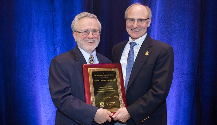 Samuel Cohen, M.D., Ph.D., left, receives the ACT Distinguished Scientist Award from Anthony Kiorpes, Ph.D., D.V.M., president of the American College of Toxicology.