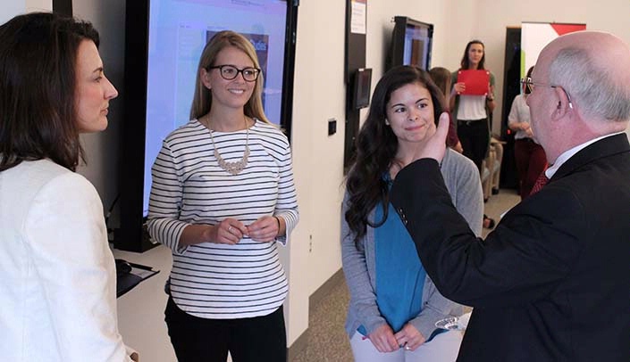 From left, Betsy Becker, associate professor of physical therapy in the UNMC College of Allied Health Professions, Kenda Frenzel, physical therapy student, Audreana Aguilar, physical therapy student, and external advisor Brad Fenwick, D.V.M., Ph.D., at the April "Innovations in Education" showcase.