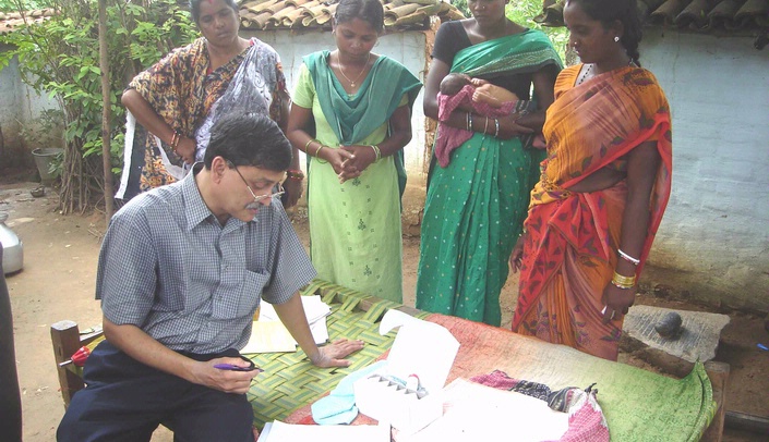 Dr. Pinaki Panigrahi monitors a baby's progress in a clinical trial in India.