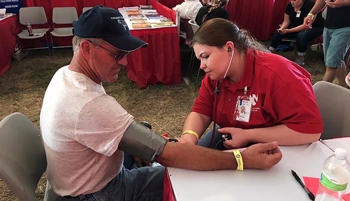 Nursing student Shayleen Hubbard of Central City, right, at Husker Harvest Days.