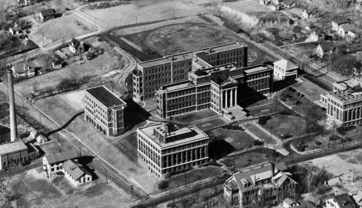 Aerial photo from 1928 shows University Hospital with 42nd Street in the foreground and, on the left, the Central Utility Plant smokestack along Emile Street.