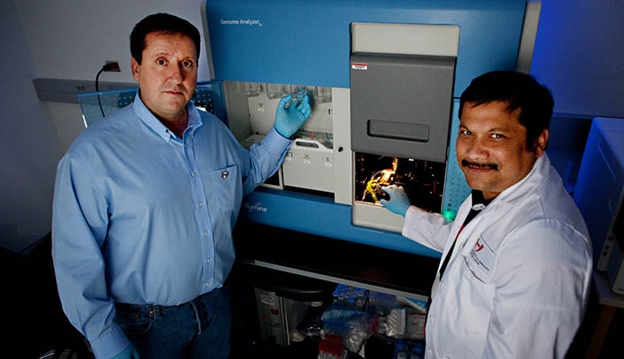 From left, James Eudy, Ph.D., director, Next Generation DNA Sequencing Core Facility, and researcher Alok Dhar, Ph.D.