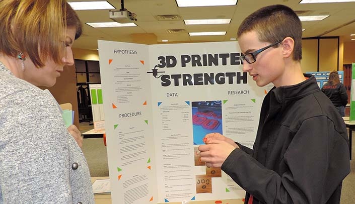 Wyatt Walker of Alliance Middle School, explains his project to Jana Schwartz, who served as one of the fair's judges. She's an extension educator with the University of Nebraska Panhandle Research and Extension Center.