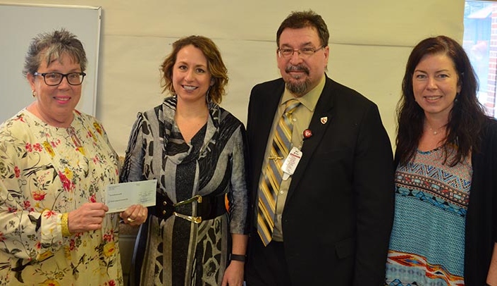 From left, Meyer Foundation President Mary McHale, Altus Architectural Studios' Angela Gerlach, Munroe-Meyer Institute Director Karoly Mirnics, M.D., Ph.D., and Nicole Giron, associate director of recreational therapy at MMI.