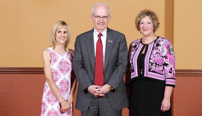 UNMC Chancellor Jeffrey P. Gold, M.D., poses with 40-year honorees Laurie Wieting, left, and Barbara Berg Glover.