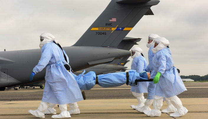 Airmen from the 628th and 375th Aeromedical Evacuation Squadrons transport a simulated highly infectious patient during a training exercise with UNMC-led investigators. (Photo by Airman 1st Class Joshua Maund)