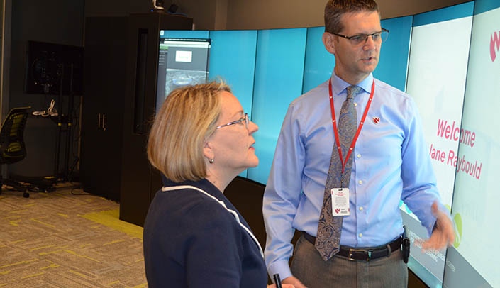 Senate candidate Jane Raybould speaks with Ben Stobbe, executive director for clinical simulation at iEXCEL, during her visit to UNMC.