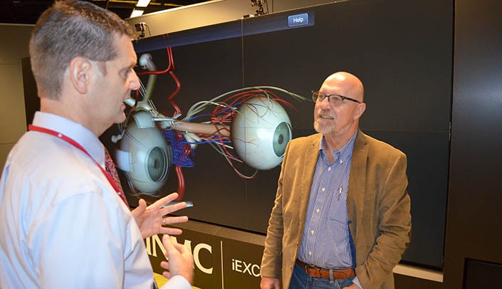 Scott Winkler, right, with Ben Stobbe, executive director of clinical simulation, toured the iEXCEL Visualization Hub during his visit to UNMC.