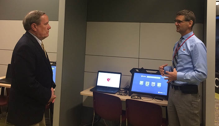 Newly elected State Sen. Mike Moser, left, speaks with Ben Stobbe, assistant vice chancellor for clinical simulation, iEXCEL, during his tour of the iEXCEL Visualization Hub.