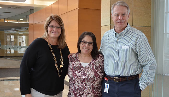 Betty Revers, center, will soon be retiring after a 40-year career at UNMC. She's flanked by two of her colleagues in comparative medicine -- Tricia Rump, business manager, and John Bradfield, D.V.M., director.
