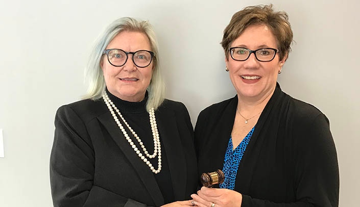 Ally Dering-Anderson, Pharm.D., receives the gavel of the NPA presidency from Joni Cover, J.D., CEO of the Nebraska Pharmacists Association