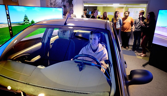 University of Nebraska at Kearney student Jenn Nolda at the wheel of the SENSEI driving simulator.