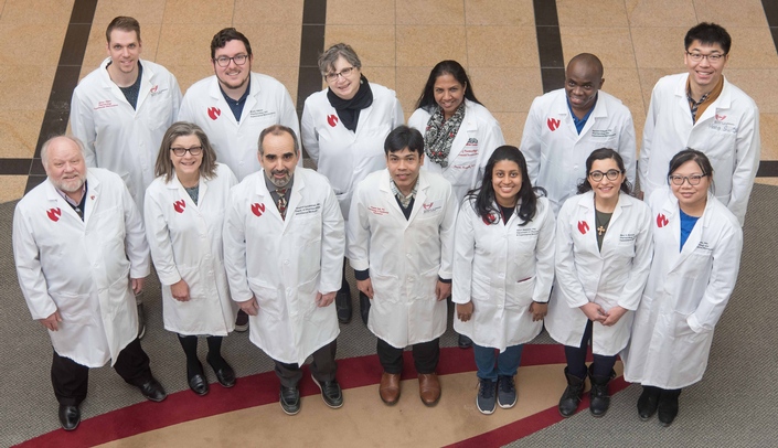 Members of the UNMC research team included: Back row (left-right) - James Hilaire, Brady Sillman, Ph.D., Larisa Poluektova, M.D., Ph.D., Santhi Gorantla, Ph.D., Benson Edagwa, Ph.D., and Hang Su; Front row -- R. Lee Mosley, Ph.D., JoEllyn McMillan, Ph.D., Howard Gendelman, M.D., Prasanta Dash, Ph.D., Saumi Mathews, Ph.D., Mary Banoub, and Zhiyi Lin. Missing from photo - Aditya Bade, Ph.D. and Nagsen Gautam, Ph.D.