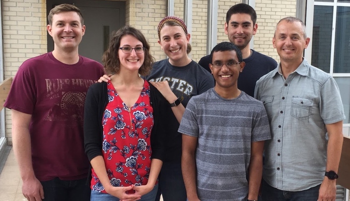 Current and former members of the Bourret laboratory. From left to right: Dr. Jeff Shaw (INBRE alum), Megan Hess (undergraduate researcher), Amanda Zalud (Ph.D. candidate), Sam Koshy (undergraduate researcher), William Boyle (Ph.D. candidate), and Dr. Travis Bourret.