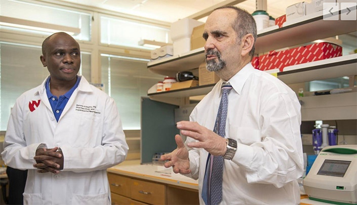 Drs. Benson Edagwa (left) and Howard Gendelman talk about the University of Nebraska Medical Center's HIV research.