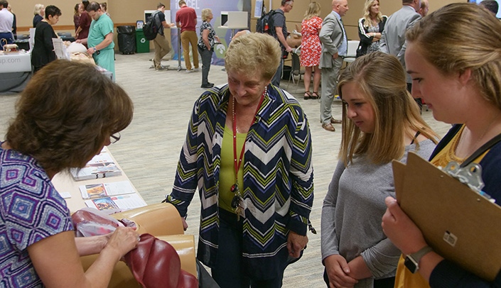 The iEXCEL team has hosted several showcase events on campus. Here, Pam Boyers, Ph.D., (center) associate vice chancellor for clinical simulation for iEXCEL, checks out the featured technology.