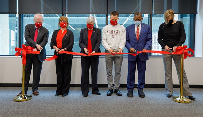 From left; Jeffrey P. Gold, MD, chancellor; Karen Honeycutt, PhD, chair, Library Advisory Group; Emily McElroy, dean, McGoogan Health Sciences Library; Tom Schroeder, president of the Student Senate; Dele Davies, MD, senior vice chancellor for academic affairs; and Brandy Clarke, PhD, president of the Faculty Senate, cut the ribbon to mark the rededication of the Leon S. McGoogan Health Sciences Library.