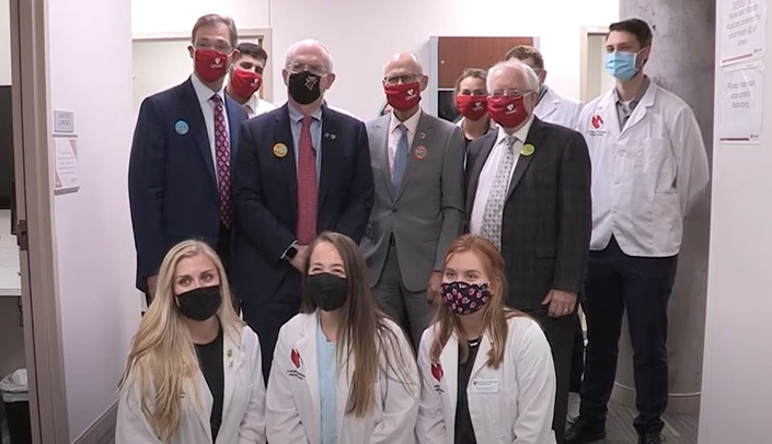 UNMC leaders, including Kyle Meyer, PhD, dean of the College of Allied Health Professions, Chancellor Jeffrey P. Gold, MD, Keith Olsen, PharmD, dean of the College of Pharmacy, and Bradley Britigan, MD, dean of the College of Medicine, stand with pharmacy students at a flu shot clinic last month.