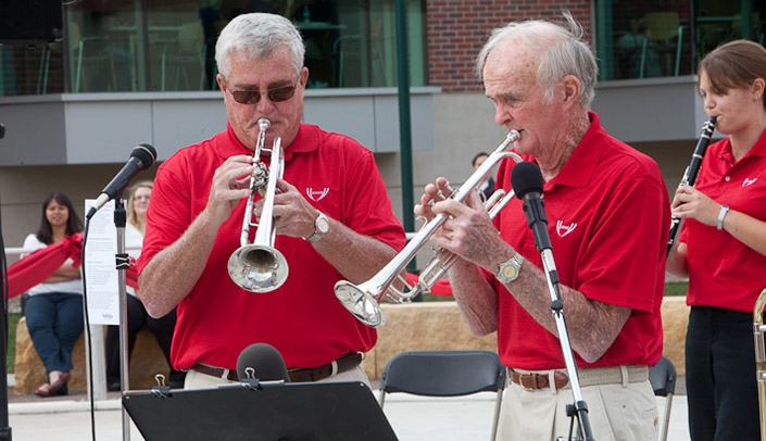 Bill Scott turned 91 this week. Here, Scott is playing his beloved trumpet, at a 2011 UNMC event with his son, John.