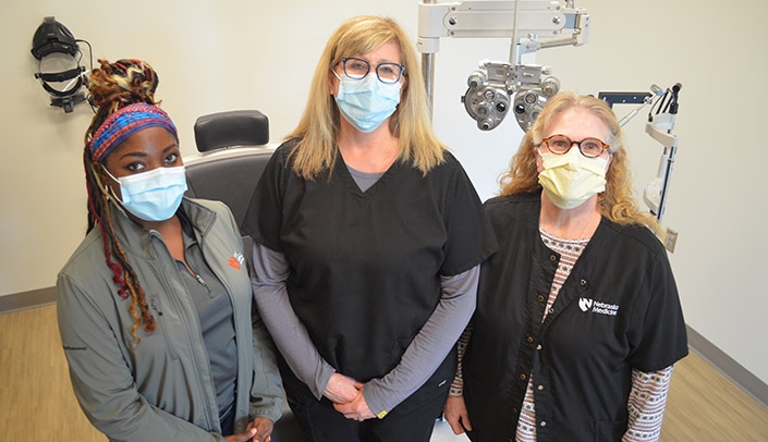 From left, technician Alison Erickson, clinic director Karen Wilson, OD, and optician Lori Cervantes at the Munroe-Meyer Institute's Caring for Champions Program Vision Clinic.
