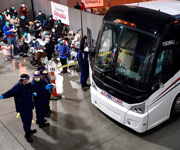 Americans arrive from China for monitoring at Camp Ashland.