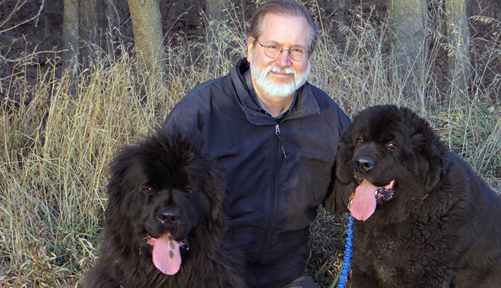 Tom Tape, MD, with two of his Newfoundland dogs. His love of dogs is what led Dr. Tape to UNMC.