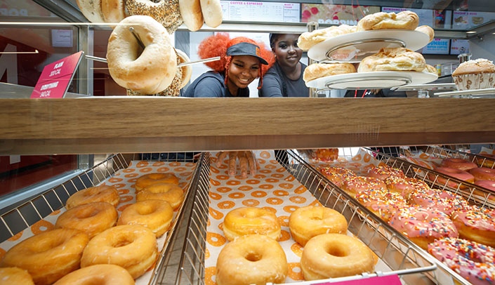 Ariana Crawford, left, and Kuiy Gal serve up the treats at the new Dunkin' located inside the Wigton Heritage Center on the fourth floor of Wittson Hall.