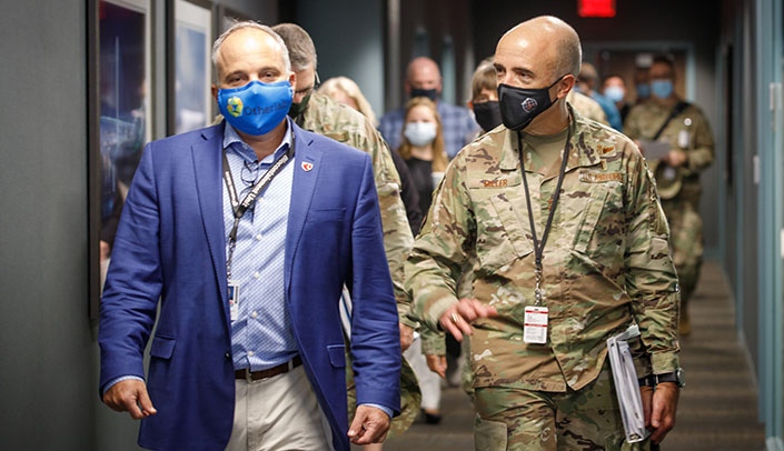 James Lawler, MD, executive director of international programs and innovation at the Global Center for Health Security, escorts Gen. Robert Miller, MD, the surgeon general of the U.S. Air Force, during his visit to UNMC.