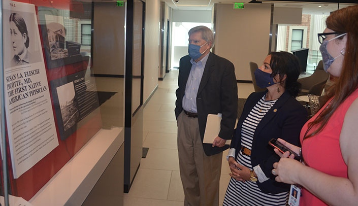 State Sen. Jen Day, center, views the Susan LaFlesche Picotte exhibit during a tour of UNMC with Bob Bartee, vice chancellor of external relations, and Carrie Meyer, assistant professor at the McGoogan Health Sciences Library.