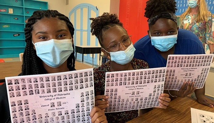 Participants in Nebraska Medicine's Girls Inc. Health Sciences Day look over material provided by the McGoogan Health Sciences Library staff.