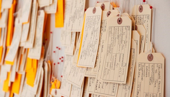 Handwritten toe tags that represent migrants who have died trying to cross the Sonoran Desert of Arizona between the mid-1990s and 2019.