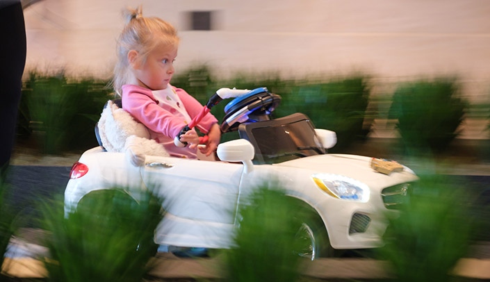 Students, volunteers and Munroe-Meyer Institute staff members modified toy cars for 11 children at Saturday's event.