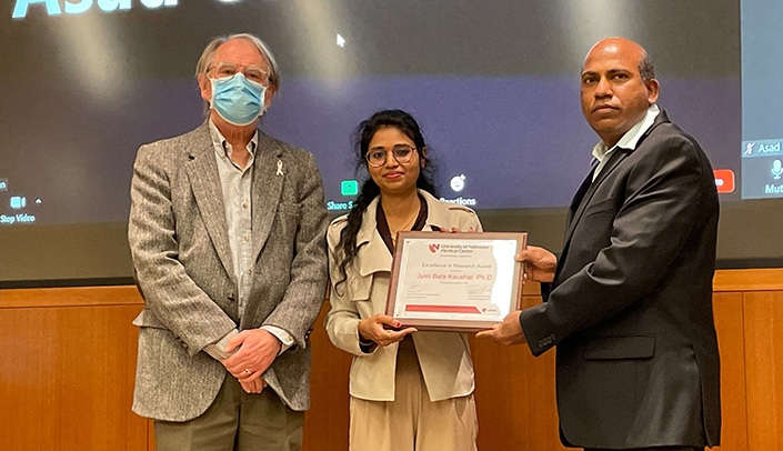 From left, Keith Johnson, PhD, Jyoti Bala Kaushal, PhD, and her mentor Satyanarayana Rachagani, PhD, at the award ceremony.