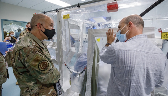 At right, David Brett-Major, MD, one of the newly named Global Center for Health Security scholars, talks with Lt. Gen. Robert Miller, surgeon general for the U.S. Air Force,  during a 2021 tour of UNMC's Davis Global Center.