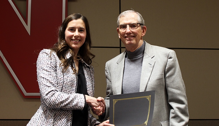 Dr. Ernest Sigler receives a faculty recognition award.