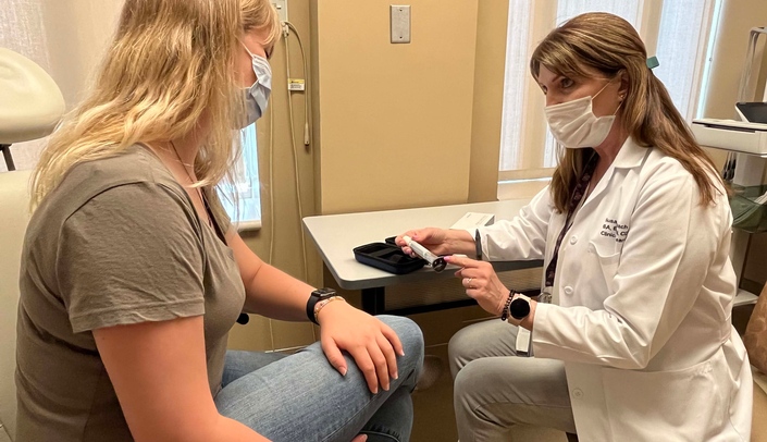 Susan Burbach, right, a clinical research nurse coordinator in the UNMC Department of Internal Medicine Division of Diabetes, Endocrine and Metabolism, shares how to properly administer diabetes medication.