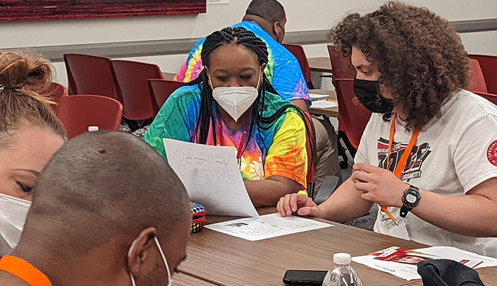 MMI's Jacqueline Hankins-Berry works with a student during the Health and Wellness Event.