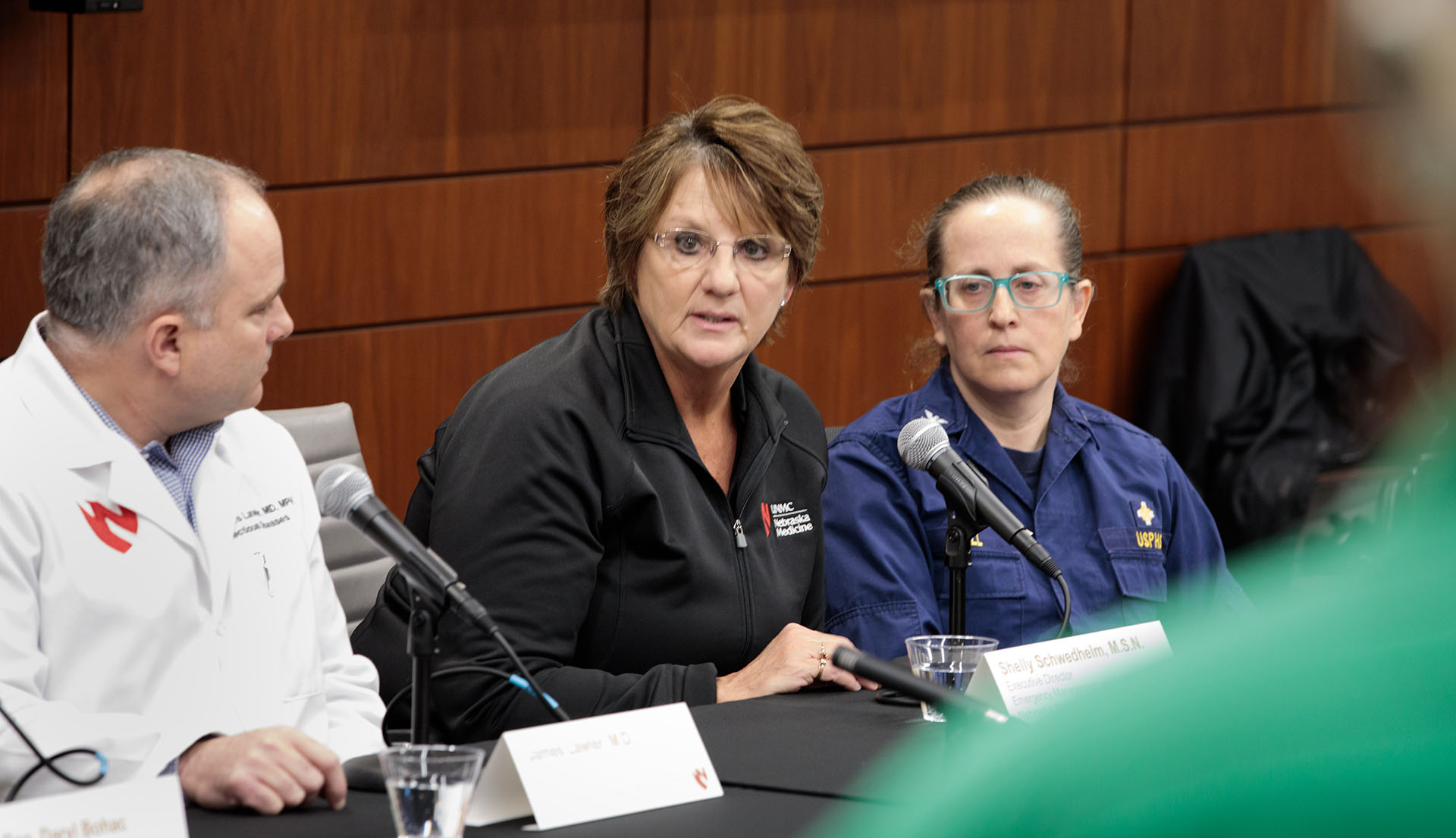 Shelly Schwedhelm, executive director of emergency management and clinical operations at the Global Center for Health Security, addresses a press conference in February 2020 about the emerging coronavirus pandemic. At left is James Lawler, MD, executive director of international programs and innovation for the GCHS. (Kent Sievers/UNMC)