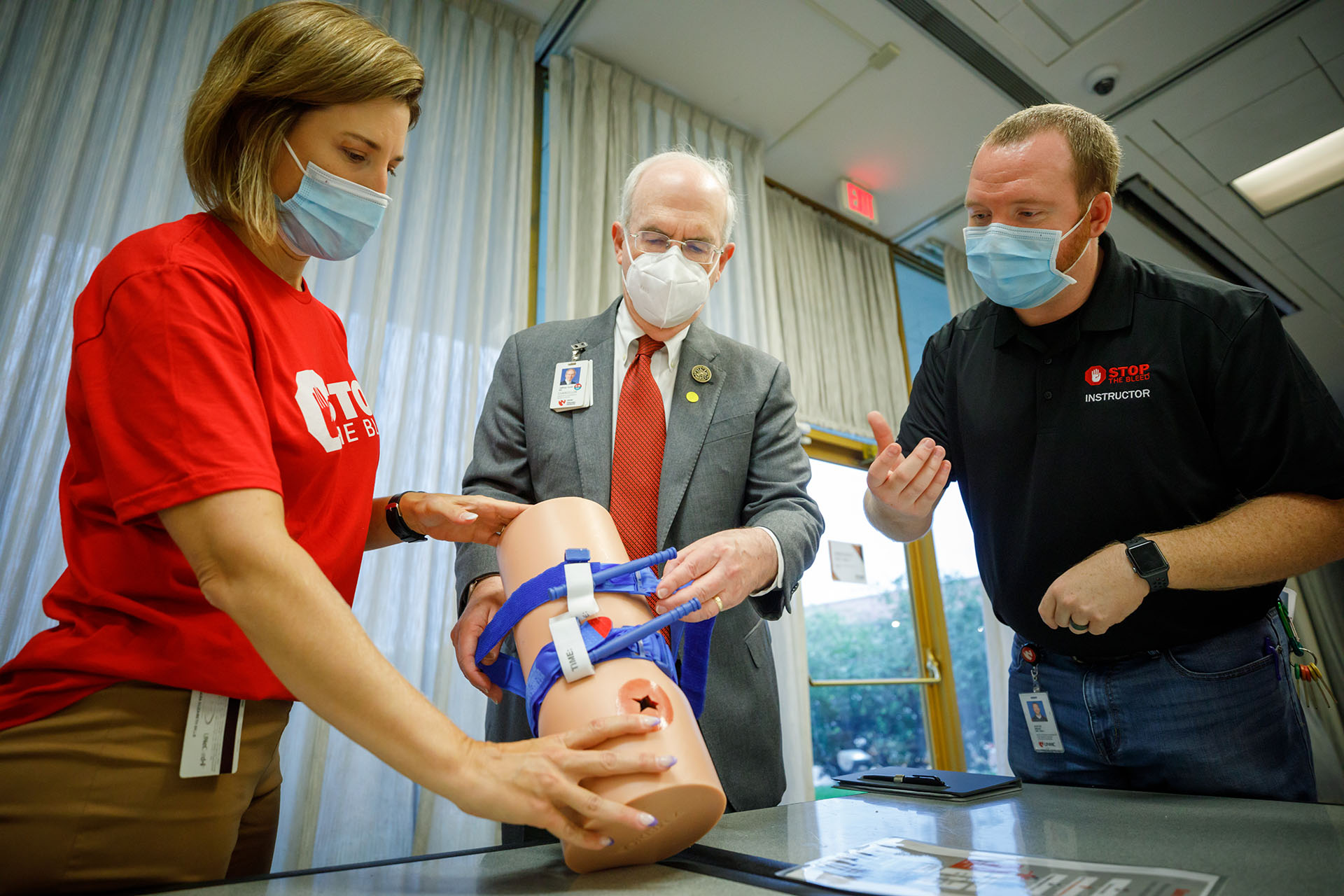 Sara Bills&comma; DPT&comma; an assistant professor and associate director of the UNMC Division of Physical Therapy Education&comma; trains with a tourniquet with UNMC Chancellor Jeffrey P&period; Gold&comma; MD&comma; and Austin Brake&comma; program coordinator for the UNMC HEROES Program&comma; during Monday’s Stop the Bleed training&period;