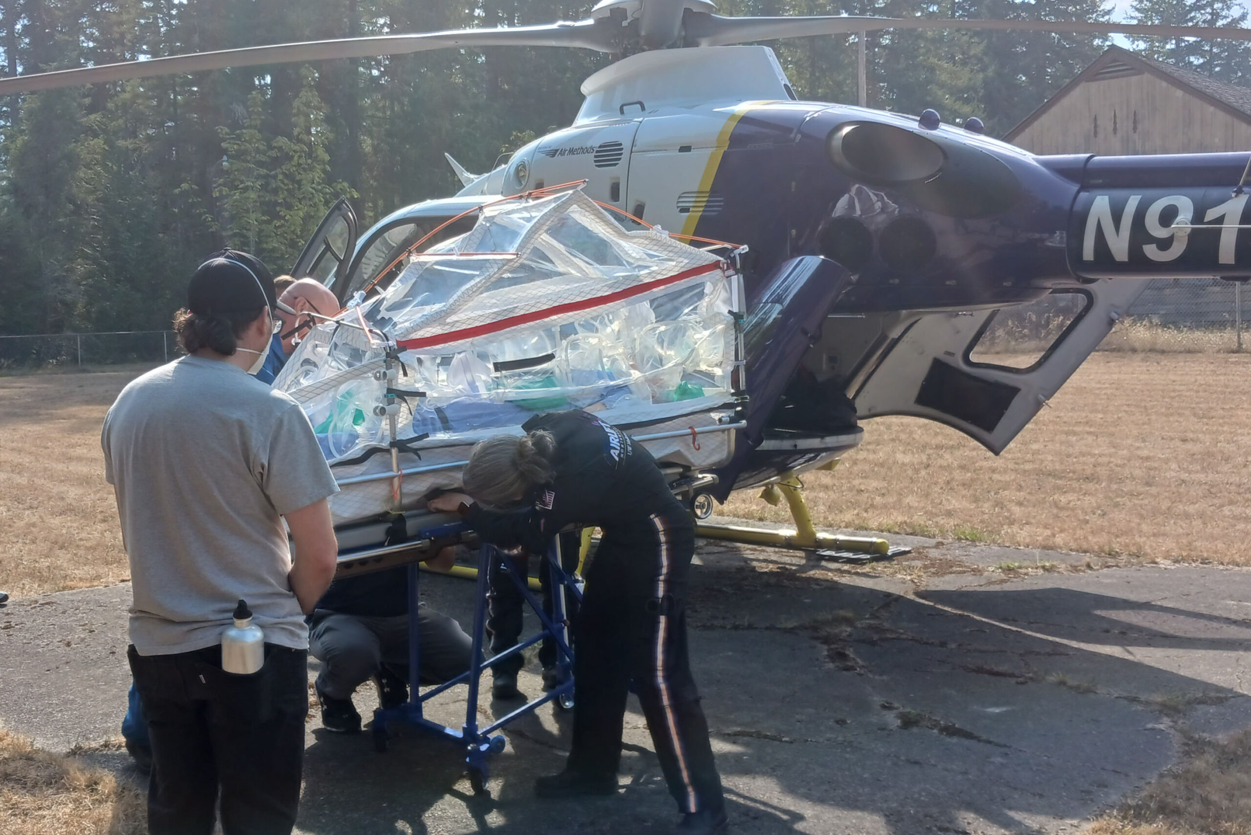 A flight crew preps the ISTARI &lpar;Isolation System for Treatment and Agile Response for high-risk Infections&rpar; prototype for loading&period;