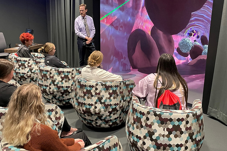 Bill Glass&comma; director&comma; visualization and technology&comma; speaks to visiting students about new technology in medical education during a tour of iEXCEL&period;