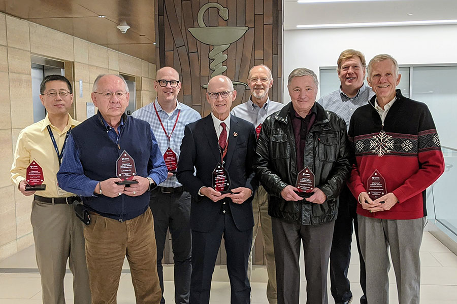 College of Pharmacy Diamond Scholars Club members&comma; Dong Wang&comma; PhD&semi; Luis Marky&comma; PhD&semi; Corey Hopkins&comma; PhD&semi; Keith Olsen&comma; PharmD&semi; Jonathan Vennerstrom&comma; PhD&semi; Yuri Lyubchenko&comma; PhD&comma; DSc&semi; DJ Murry&comma; PharmD&semi; Courtney Fletcher&comma; PharmD&period; Not pictured&colon; Ram Mahato&comma; PhD&semi; David Oupicky&comma; PhD&period;