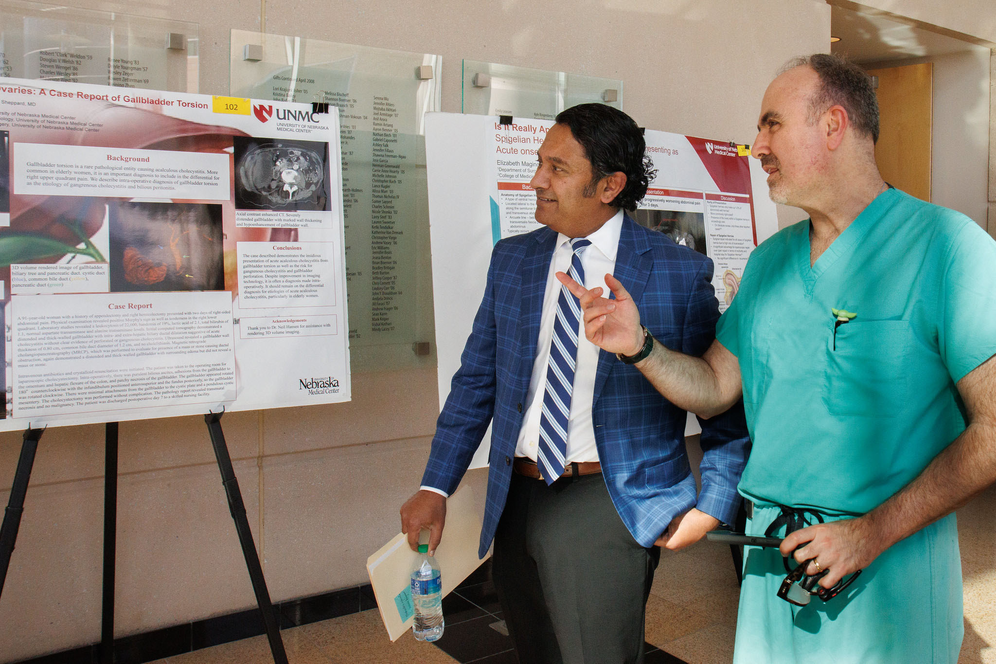 Chandra Are&comma; MD&comma; associate dean of graduate medical education&comma; left&comma; looks over a poster presentation with Iraklis Pipinos&comma; MD&period;&period;