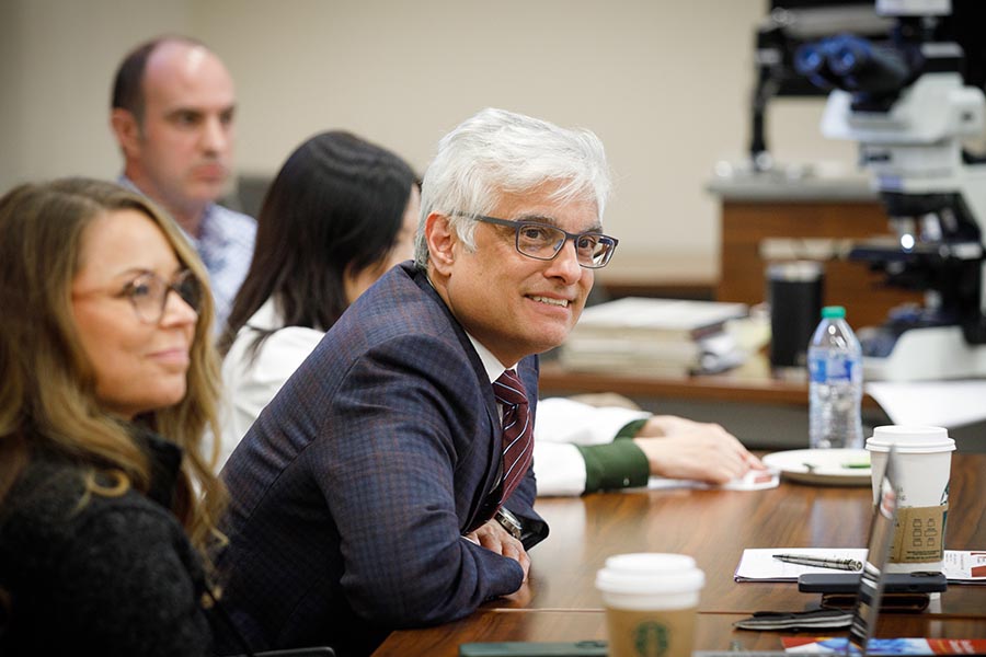 Sunil Hingorani, MD, PhD, leads a weekly pancreas multidisciplinary conference at the Fred & Pamela Buffett Cancer Center. At left is Christina Hoy, DNP, clinical program director for the Pancreatic Diseases Specialty Clinic in the Pancreatic Cancer Center of Excellence.
