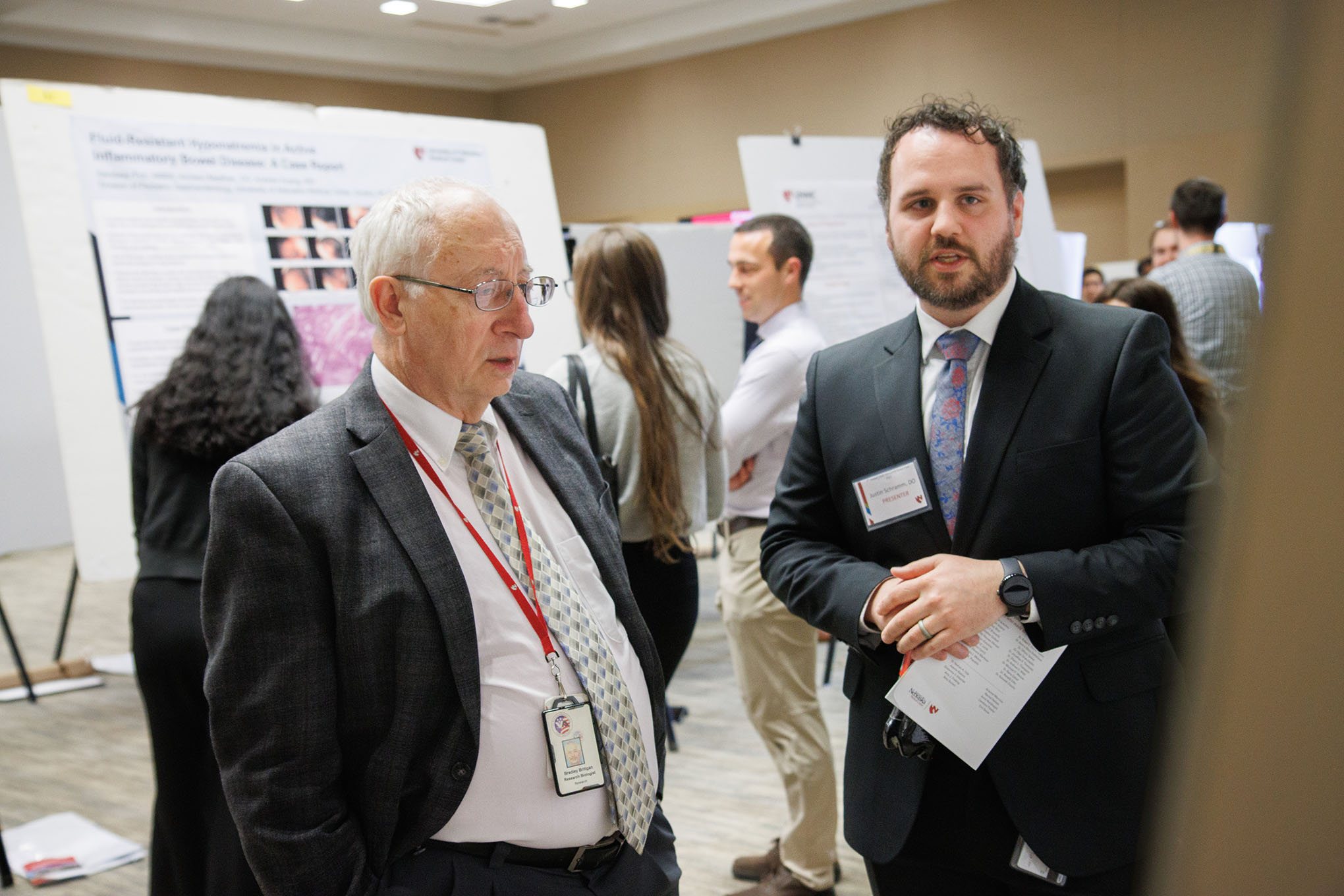 At right&comma; Justin Schramm&comma; DO&comma; presents his research to Bradley Britigan&comma; MD&comma; dean of the UNMC College of Medicine&comma; during the 5th annual UNMC Graduate Medical Education Research Symposium&period;