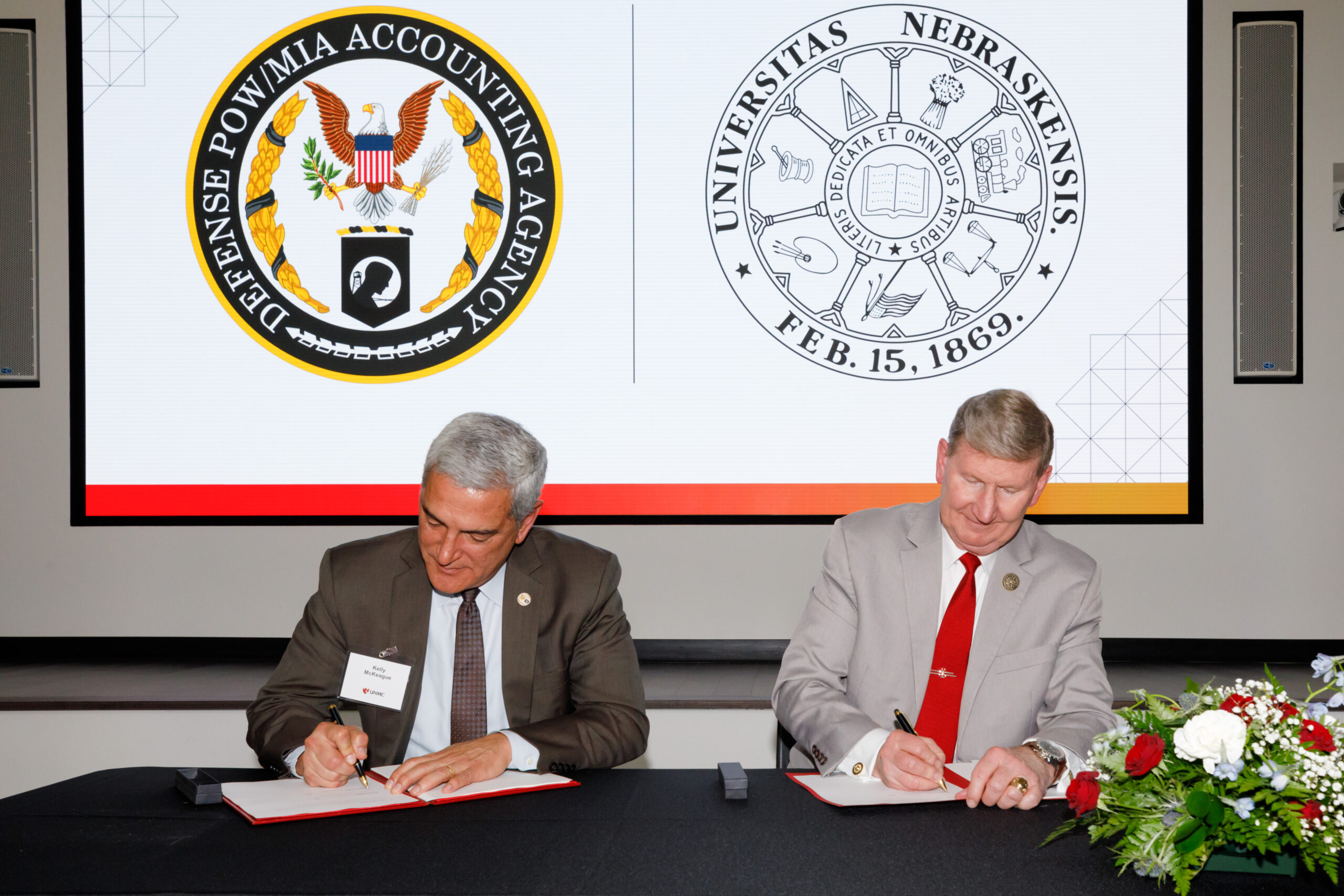 University of Nebraska President Ted Carter&comma; right&comma; and Defense POW&sol;MIA Accounting Agency Director Kelly McKeague sign a memorandum of understanding expanding collaborations between the two institutions&period;