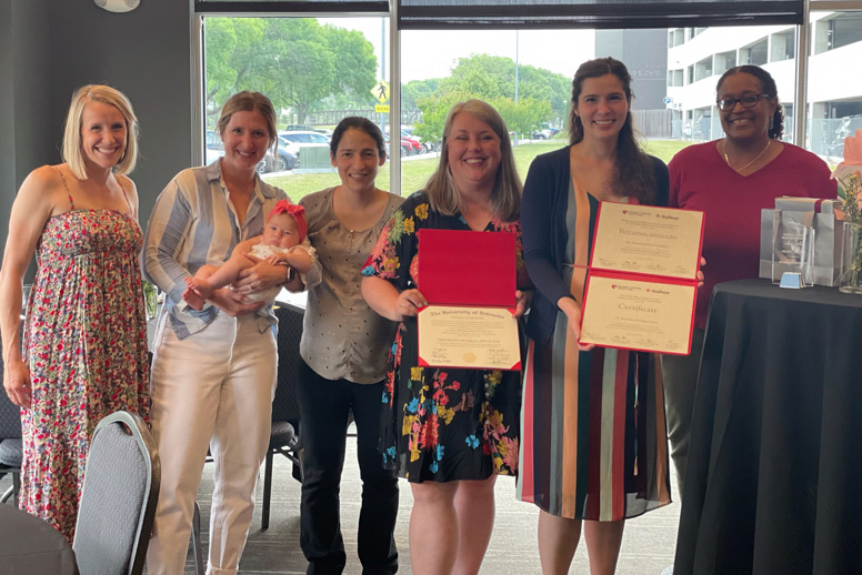 Brooklyn Leitch&comma; MD&comma; second from right&comma; celebrates her completion of the ¡SÍ&excl; program with&comma; from left&comma; Katherine MacKrell&comma; MD&comma; peds hospitalist&semi; Brooke Seaton&comma; pediatric hospital medicine fellowship program coordinator&semi; Aleisha Nabower&comma; MD&comma; associate program director&semi; Sheilah Snyder&comma; MD&comma; the program director for pediatric hospital medicine&semi; and Shirley Delair&comma; MD&comma; UNMC College of Medicine associate dean of DEI&period;