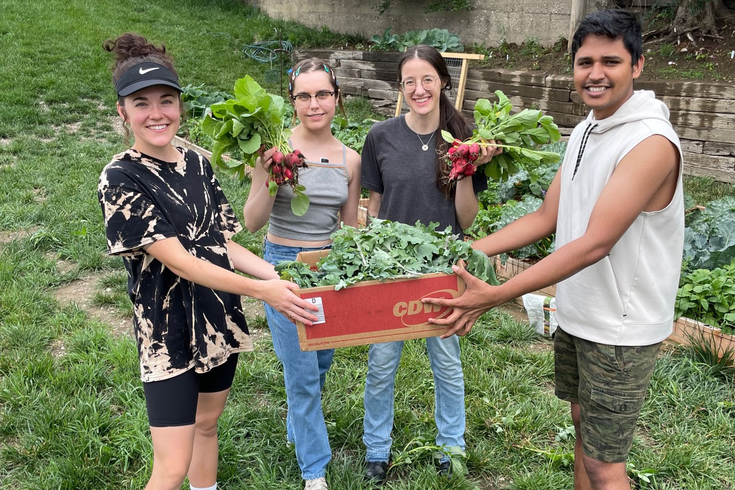 From left&comma; students Julia Quigley of the UNMC College of Public Health&comma; Caroline Case of the Eppley Institute for Research in Cancer and Allied Diseases&comma; Sadie Allen of the Eppley Institute for Research in Cancer and Allied Diseases and Venkatesh Varadharaj of the UNMC College of Medicine hold the garden’s first donation to a local community group&period;